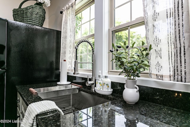 interior details featuring sink and dark stone counters