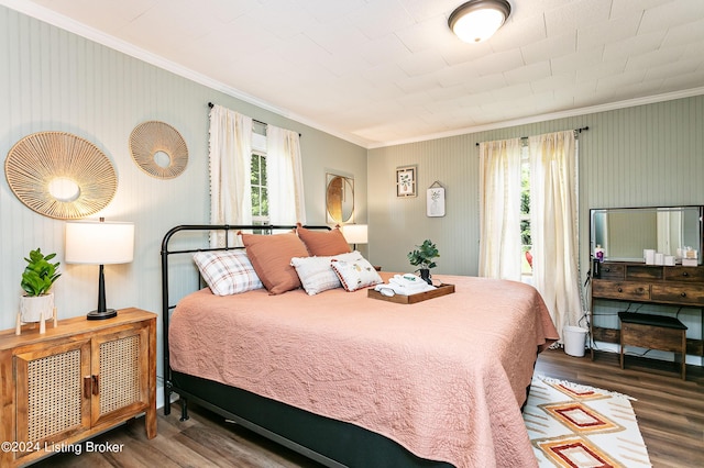 bedroom with crown molding and dark wood-type flooring