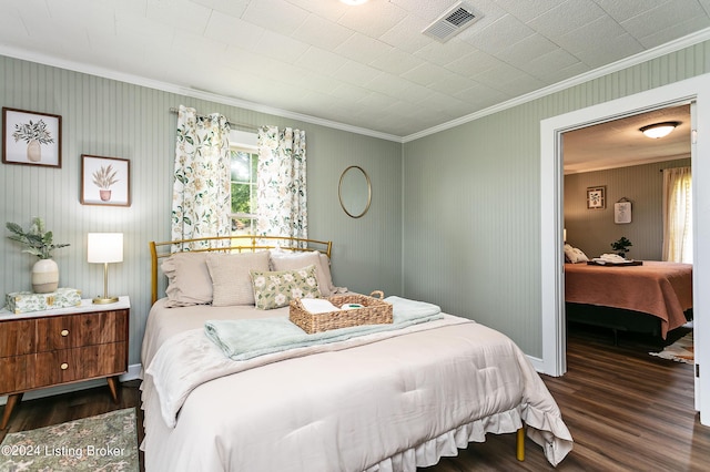 bedroom featuring crown molding and dark wood-type flooring