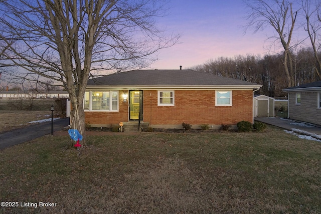 view of front of home featuring a shed and a yard