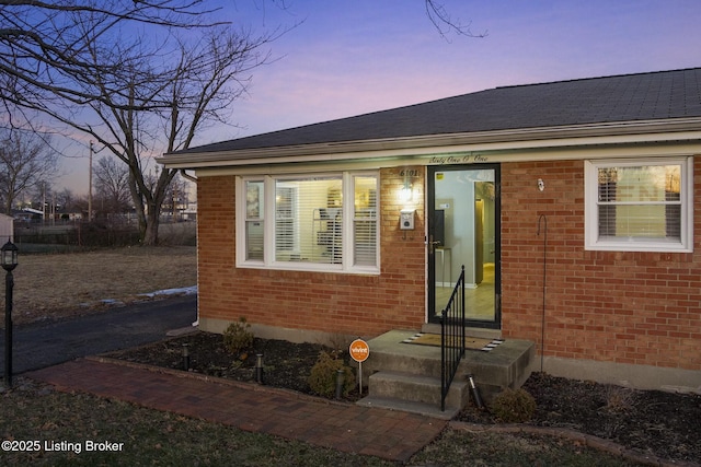 view of exterior entry at dusk