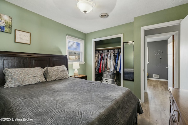 bedroom with light hardwood / wood-style flooring and a closet