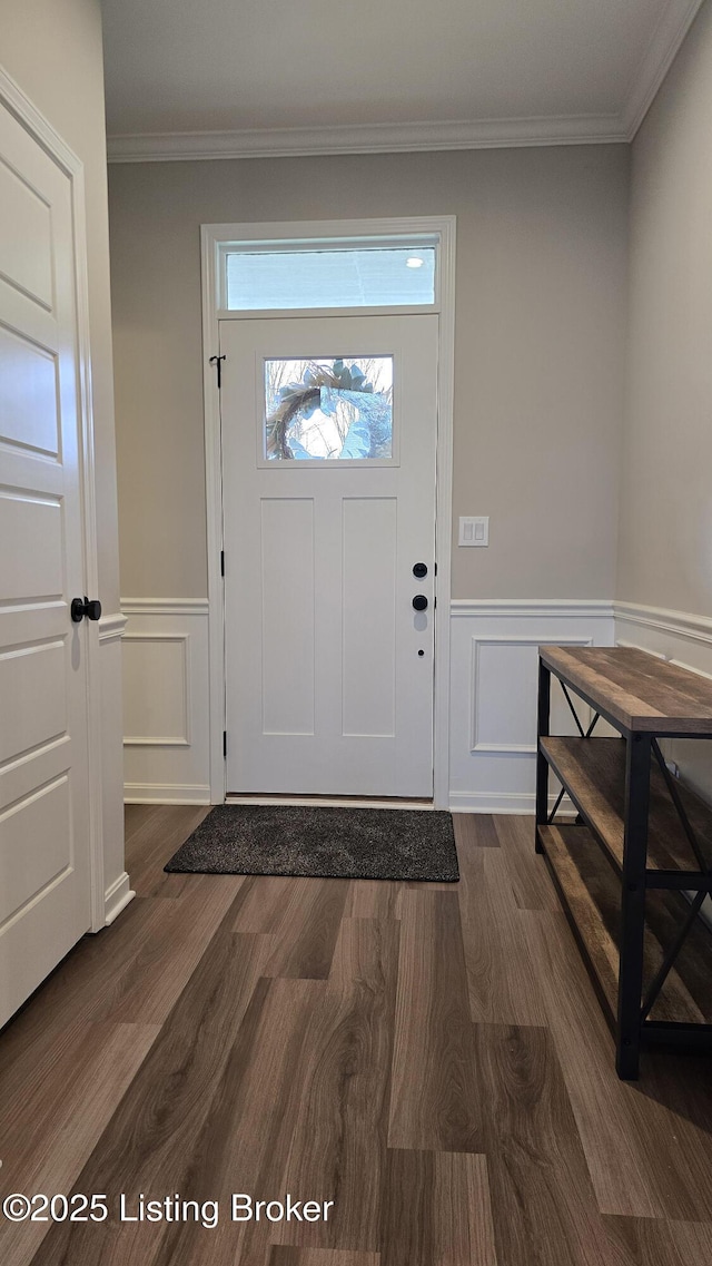 foyer featuring ornamental molding and dark hardwood / wood-style floors