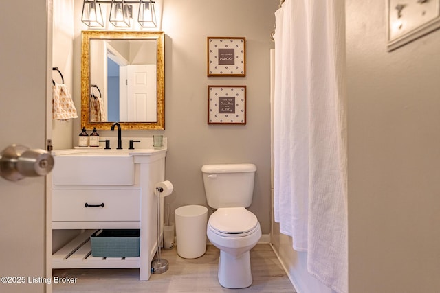 full bathroom with vanity, wood-type flooring, toilet, and shower / tub combo with curtain