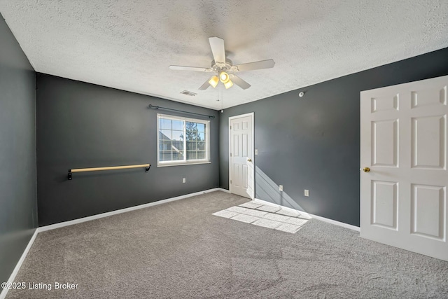 unfurnished bedroom featuring ceiling fan, carpet flooring, a closet, and a textured ceiling