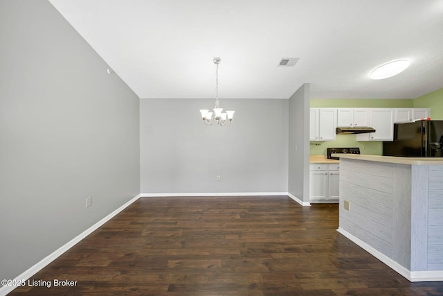 kitchen featuring pendant lighting, dark hardwood / wood-style flooring, black refrigerator with ice dispenser, and white cabinets