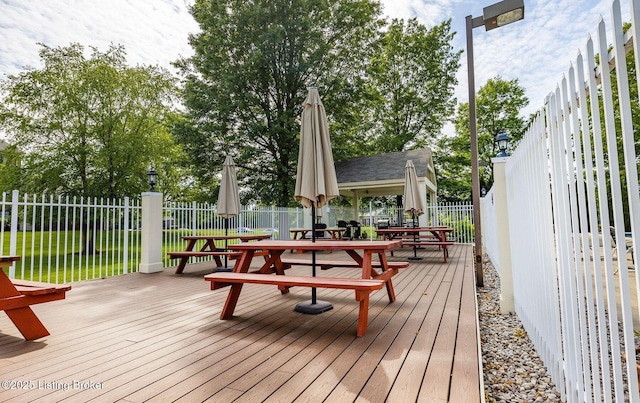 wooden terrace with a lawn