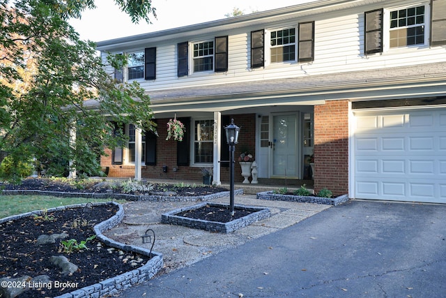 view of front of property featuring a garage and a porch