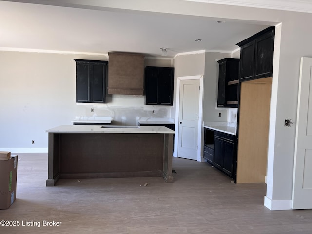 1603 Meremont Ridge Rd, Louisville, KY 40245 - kitchen featuring a kitchen island, dark cabinetry, crown molding, and light wood finished floors