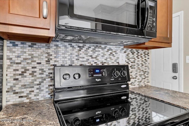 kitchen featuring tasteful backsplash, range, and dark stone counters