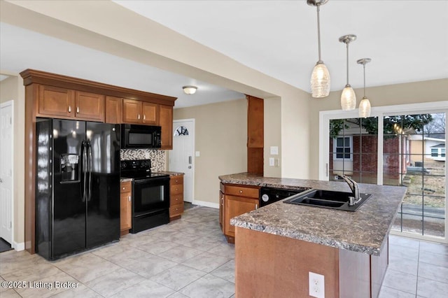 kitchen with decorative light fixtures, sink, backsplash, dark stone counters, and black appliances