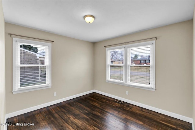 unfurnished room featuring dark hardwood / wood-style flooring