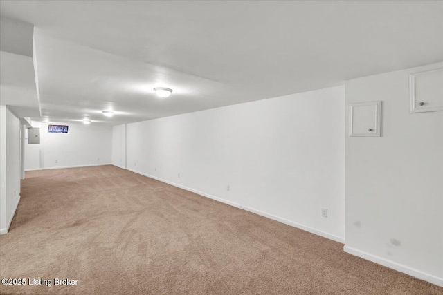 basement with light colored carpet and electric panel