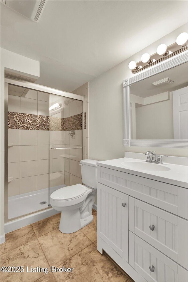 bathroom with vanity, toilet, and walk in shower