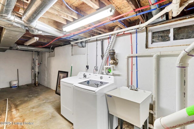 clothes washing area with sink and washer and clothes dryer