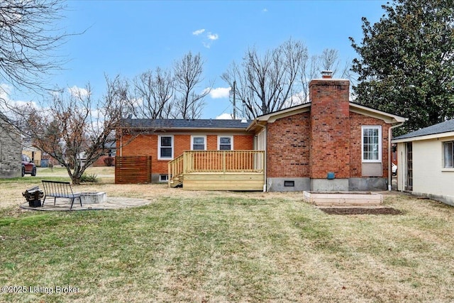 back of property with a wooden deck, a yard, and a patio area