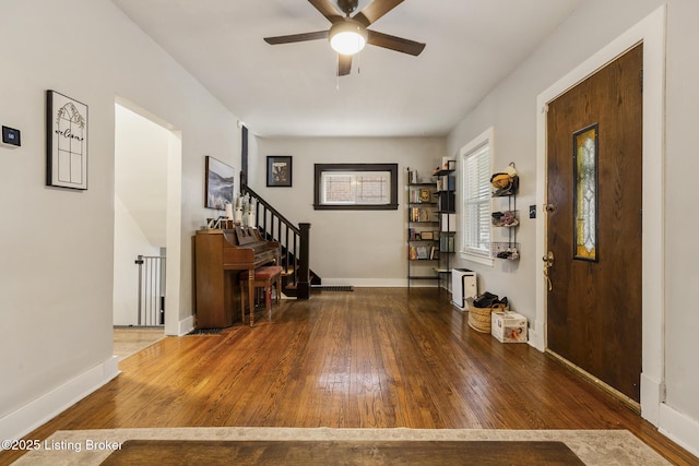 entryway with wood-type flooring and ceiling fan