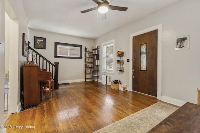 entrance foyer with dark wood-type flooring and ceiling fan