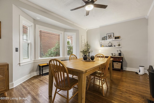 dining room with crown molding, dark hardwood / wood-style floors, heating unit, and ceiling fan