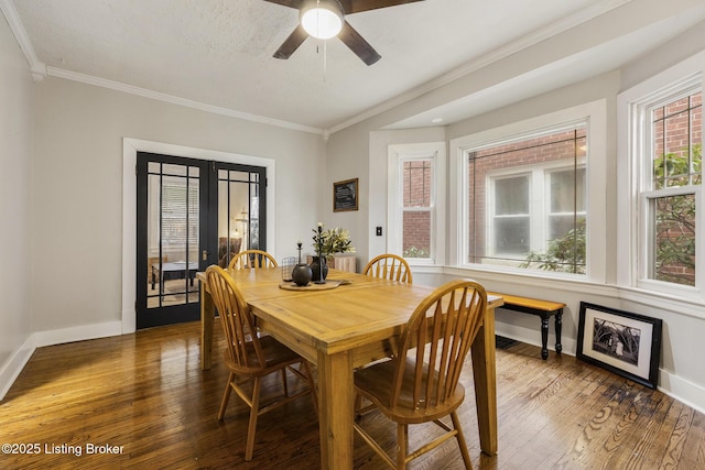 dining room featuring crown molding, dark hardwood / wood-style floors, ceiling fan, and french doors