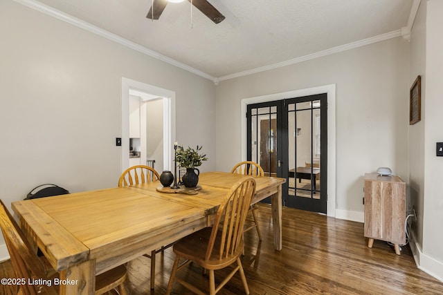 dining room with crown molding, dark hardwood / wood-style floors, ceiling fan, and french doors