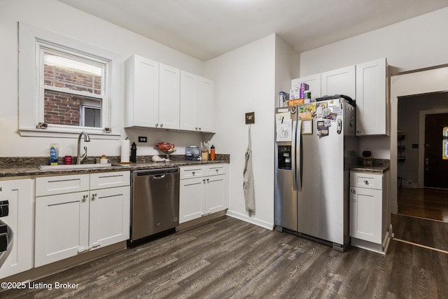 kitchen featuring appliances with stainless steel finishes, sink, white cabinets, and dark hardwood / wood-style flooring