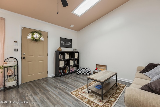 living room featuring dark wood-type flooring, ceiling fan, ornamental molding, and vaulted ceiling