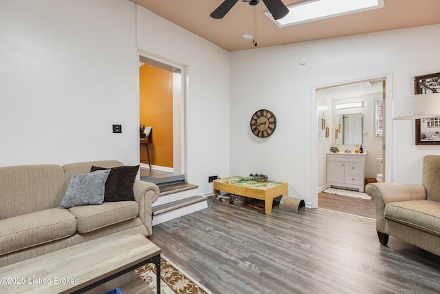 living room with hardwood / wood-style floors and ceiling fan