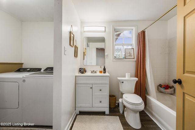 full bathroom featuring wood-type flooring, shower / bath combination with curtain, vanity, washing machine and clothes dryer, and toilet