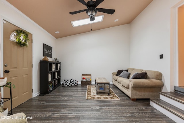 living room with ornamental molding, dark hardwood / wood-style floors, ceiling fan, and a skylight