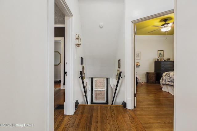 corridor with hardwood / wood-style flooring