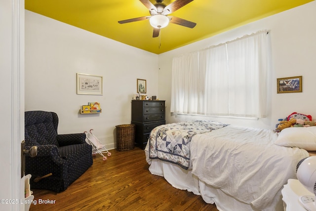 bedroom with dark hardwood / wood-style floors and ceiling fan