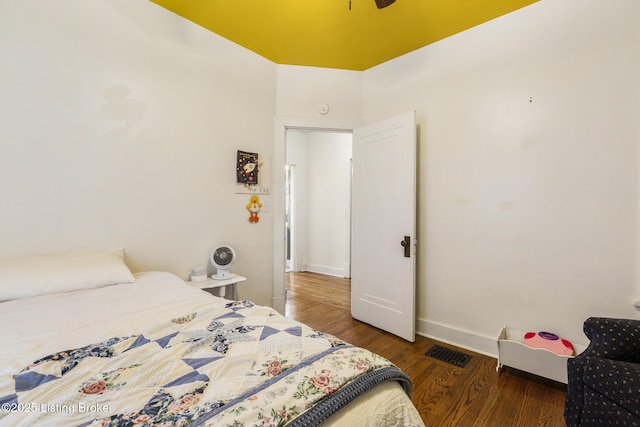 bedroom with dark wood-type flooring