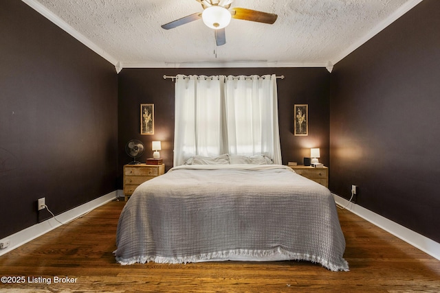 bedroom with dark wood-type flooring, ornamental molding, and a textured ceiling