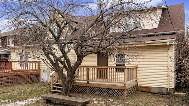 back of house with a deck