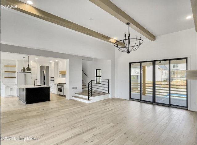 unfurnished living room featuring sink, a notable chandelier, beam ceiling, and light hardwood / wood-style flooring