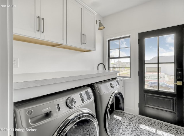 laundry area featuring cabinets and washing machine and dryer