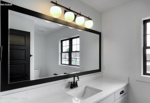 bathroom with vanity and toilet