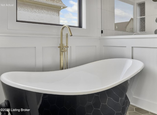 bathroom featuring tile patterned flooring and a tub