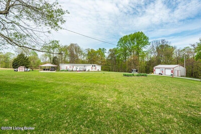 view of yard with a storage shed and a garage