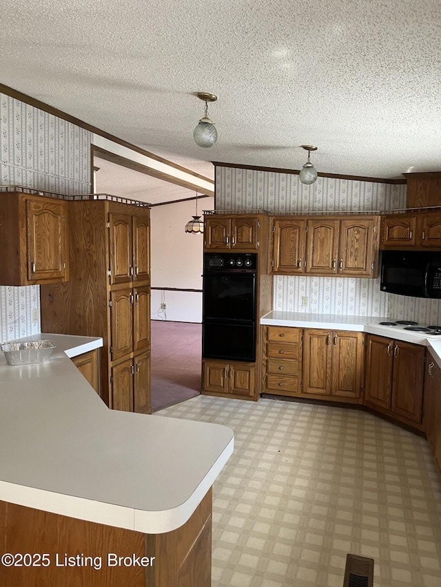 kitchen with ornamental molding, a textured ceiling, and black appliances