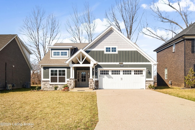 craftsman house with a garage, a front yard, and cooling unit