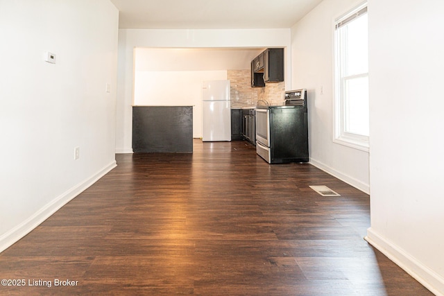 unfurnished living room featuring dark hardwood / wood-style floors