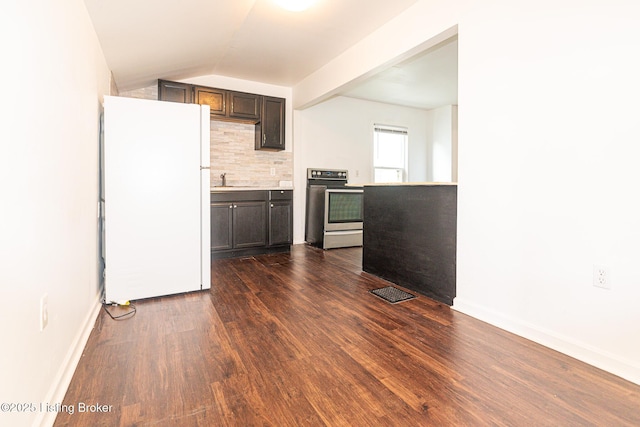 kitchen featuring dark wood-type flooring, dark brown cabinetry, tasteful backsplash, stainless steel electric range, and white fridge