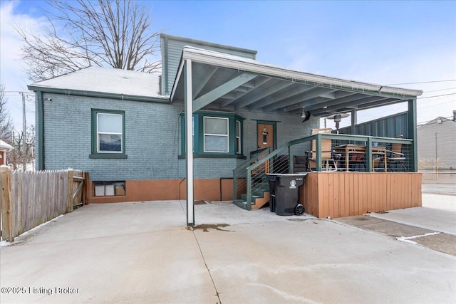 back of property with a carport