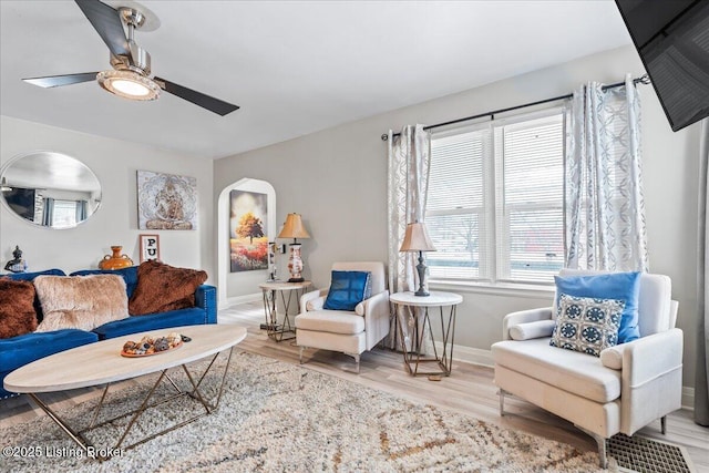 living room featuring ceiling fan and hardwood / wood-style floors