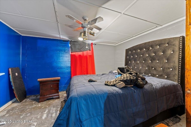 bedroom with ceiling fan and concrete floors