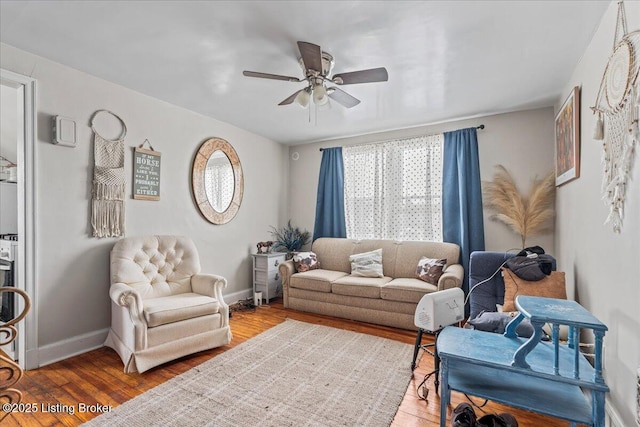 living room featuring hardwood / wood-style floors and ceiling fan