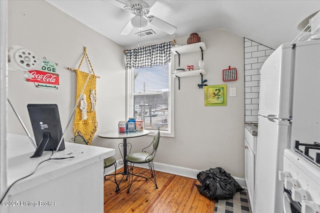 home office featuring lofted ceiling, ceiling fan, and wood-type flooring