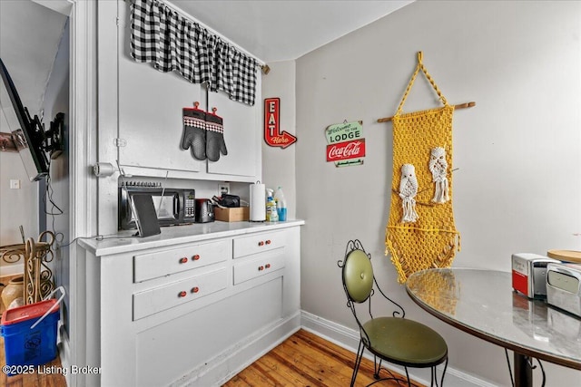 kitchen with white cabinets and wood-type flooring